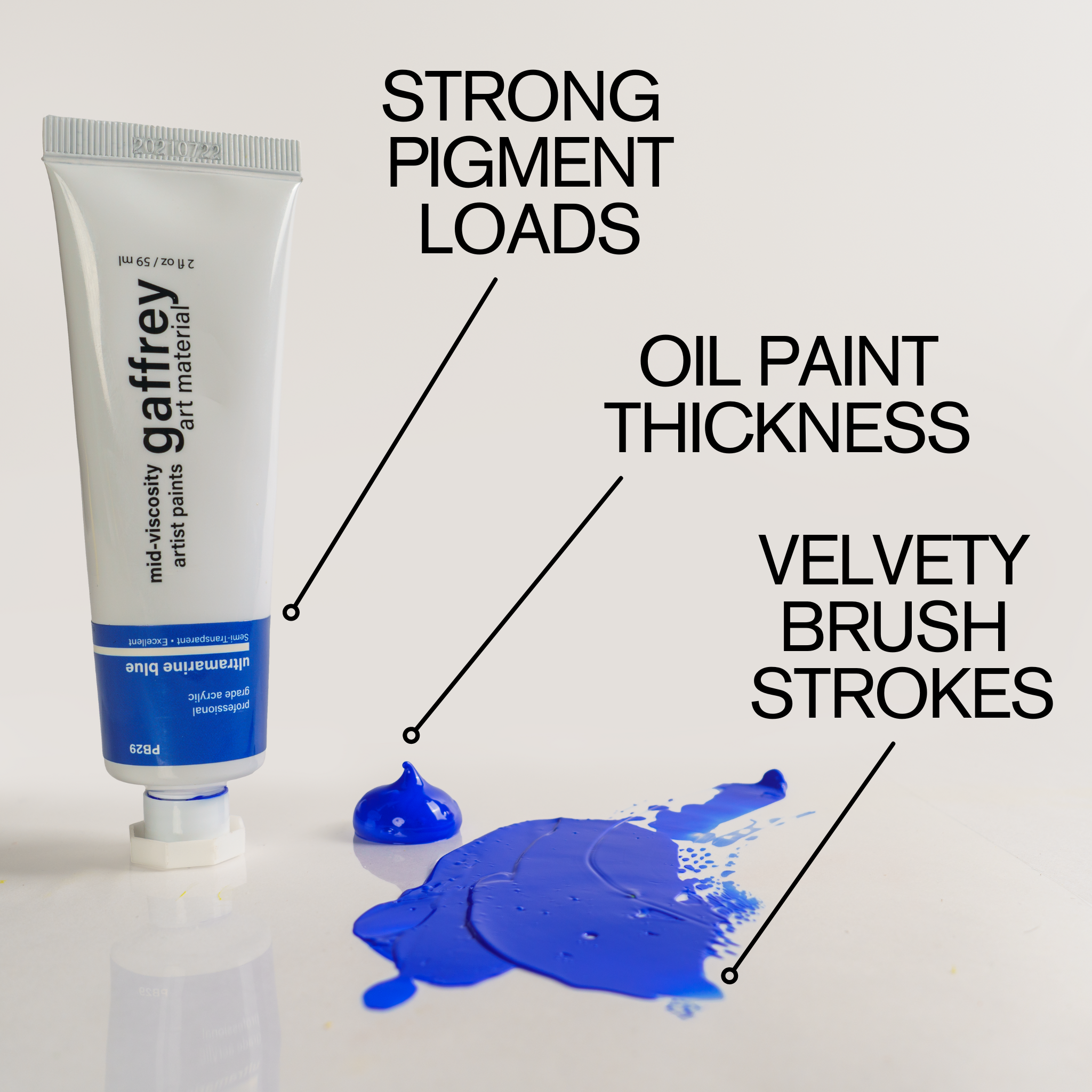 An acrylic paint tube labeled with strong pigment load next to a sample of blue paint showing oil-like thickness and velvety brush strokes.