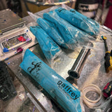 Gaffrey art material packaging on a workbench with tools and materials.